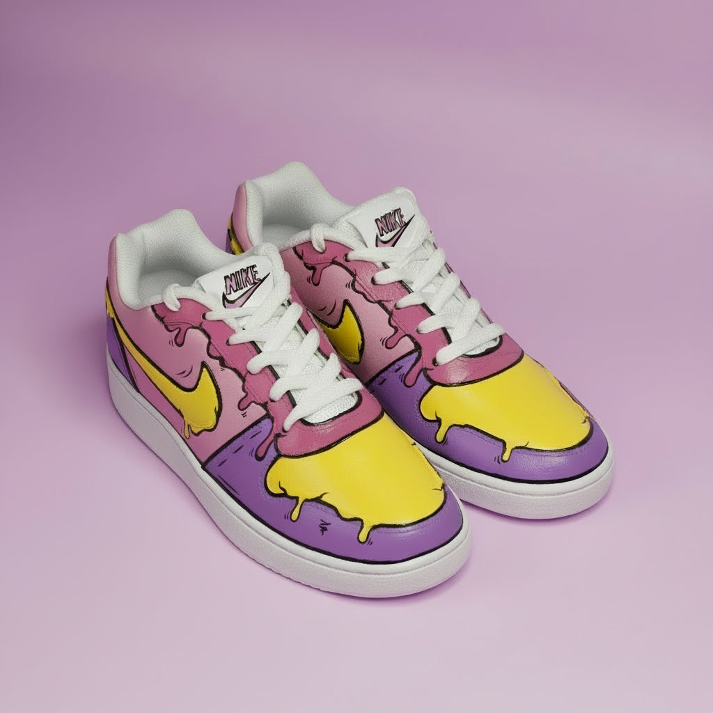 Hand-painted Pair of sneakers with purple and yellow candle melted design on a lavender background