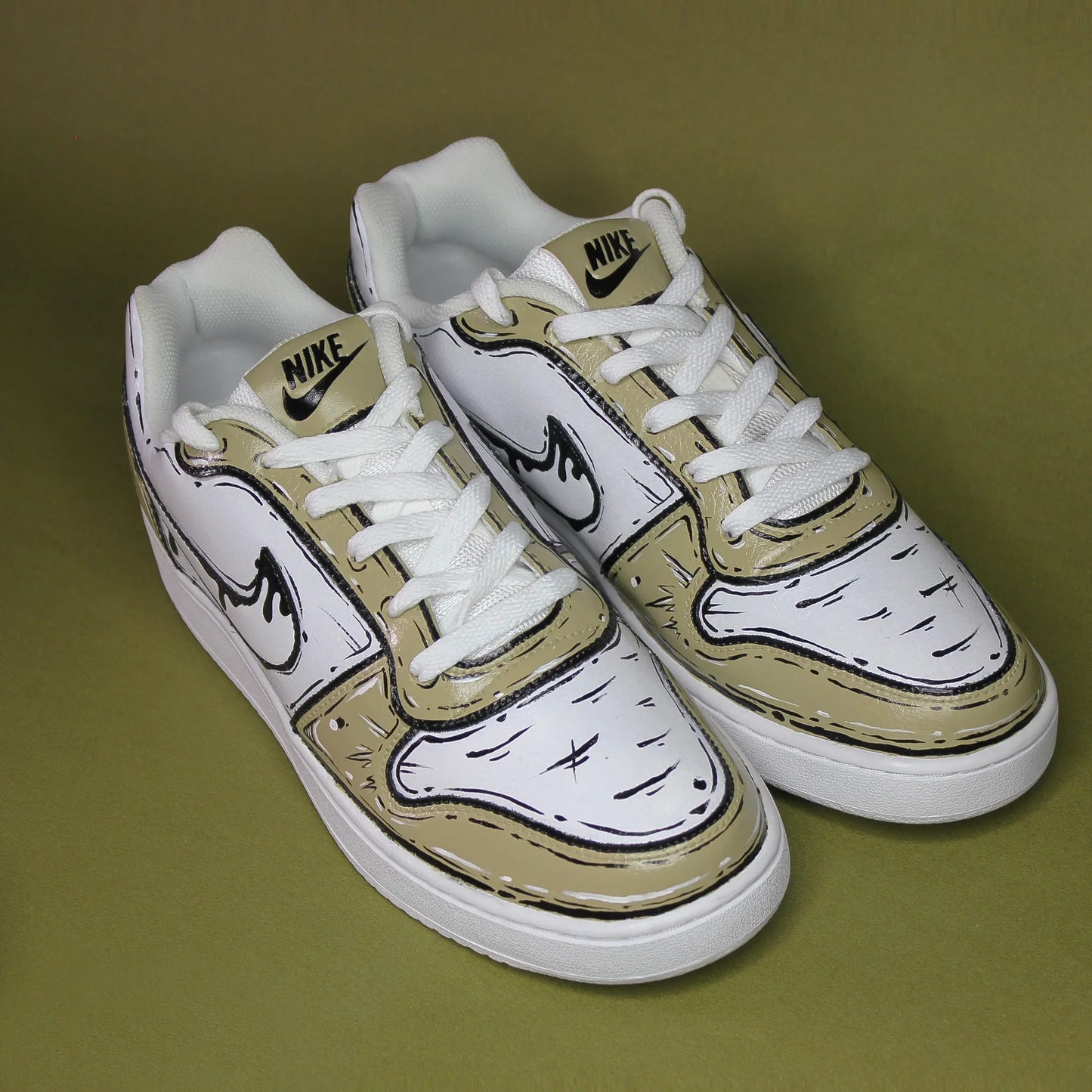 A custom-painted White Nike sneaker with olive black designs on a green background