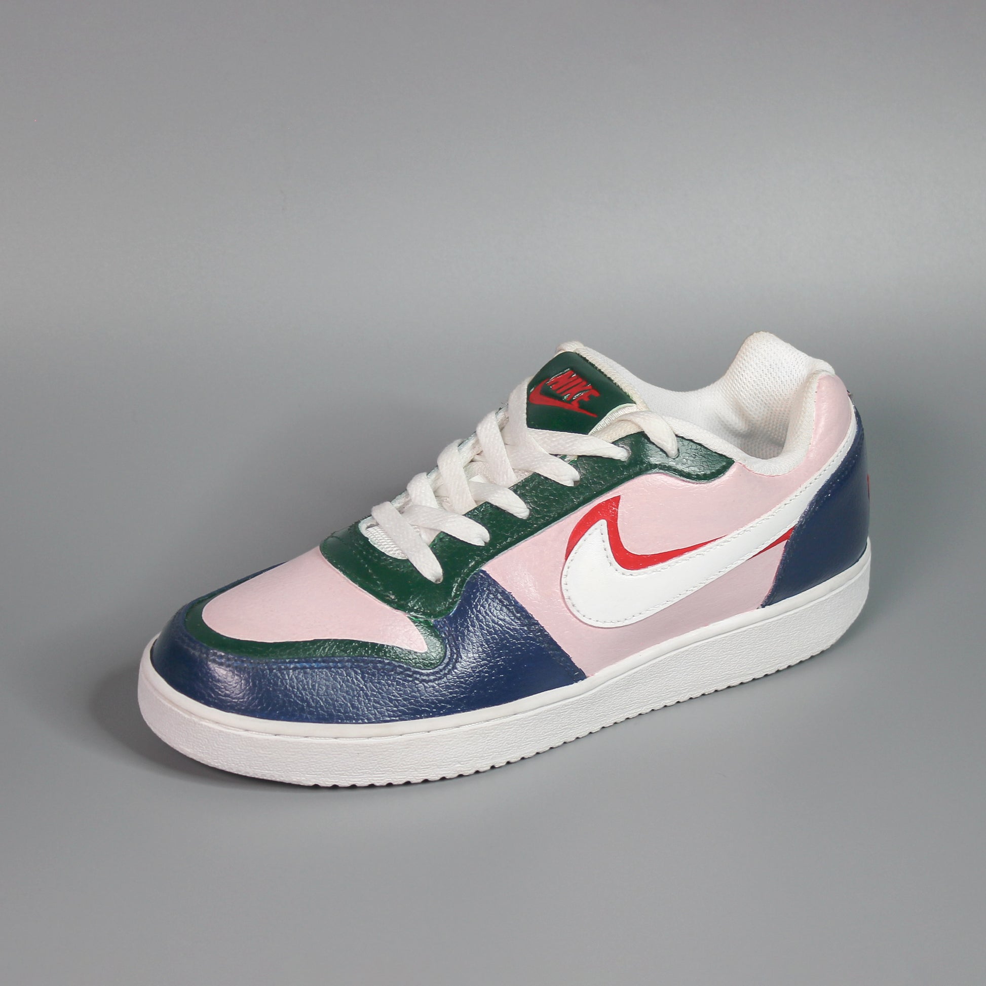 Multicoloured (green, pink, blue, red) sneaker with a hand-painted design on a gray background