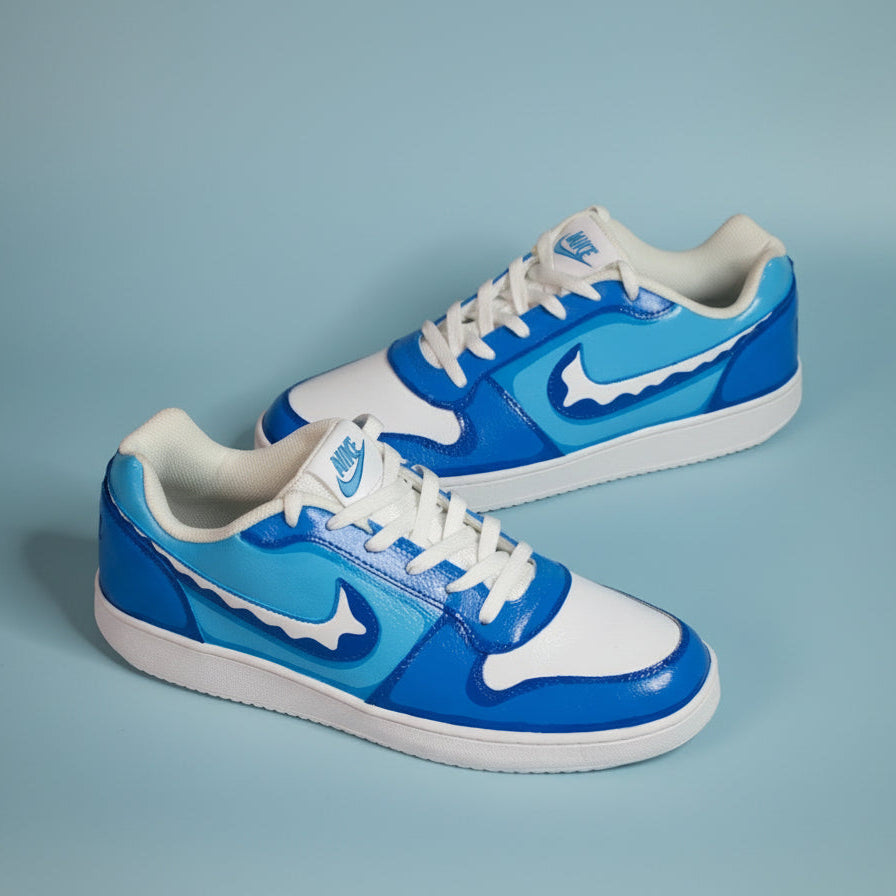 Hand-painted Blue and white sneakers representing oceanic blue on a light blue background