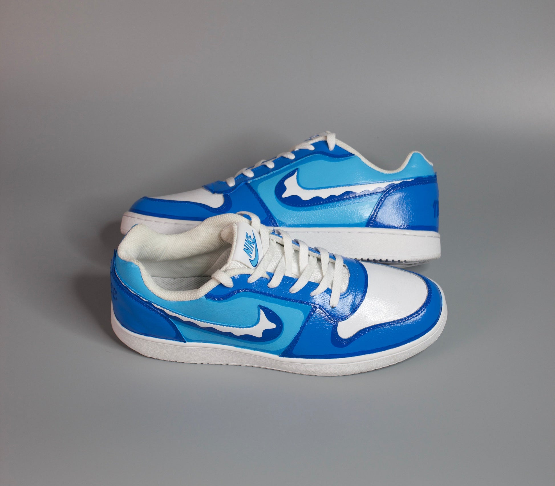 hand-painted sneaker, design inspired from blue water on a gray background