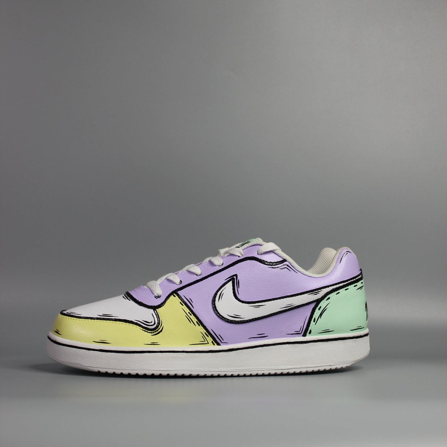 custom painted Nike Pair of sneakers with a multi color (yellow, green and purple) with comic book and cartoon design on a light grey background