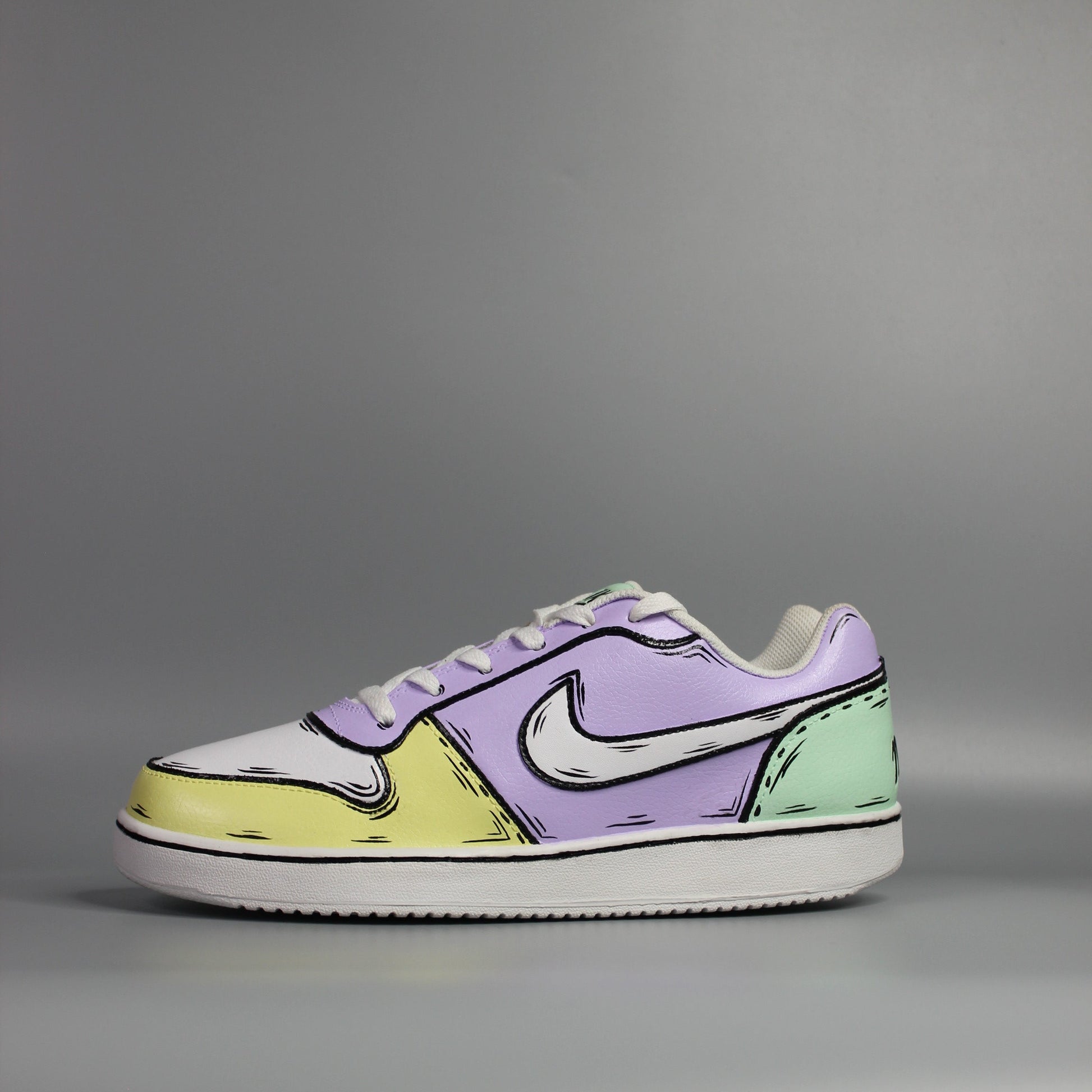 custom painted Nike Pair of sneakers with a multi color (yellow, green and purple) with comic book and cartoon design on a light grey background