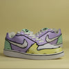 hand-painted Pair of sneakers with a multi color (yellow, green and purple) with cartoonish design on a yellow background