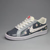Hand painted pair of Nike sneakers with floral design on a gray background 