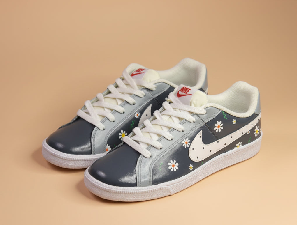 Hand-painted grey sneaker with white and  orange floral patterns on a light orange background 