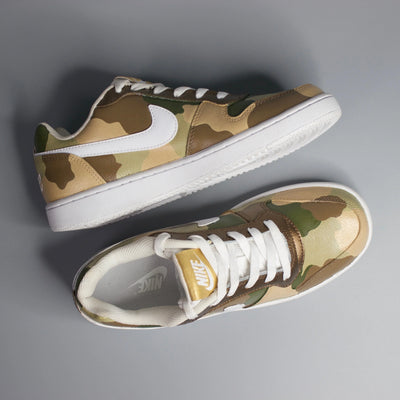 Hand-painted Military inspired Camouflage design on Nike sneakers on a gray background