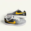 hand-painted Gray sneaker with yellow and black accents representing starts with  the sun on a white background