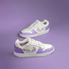 Pair of Nike white sneakers hand-painted in purple with colourful accents on a purple background