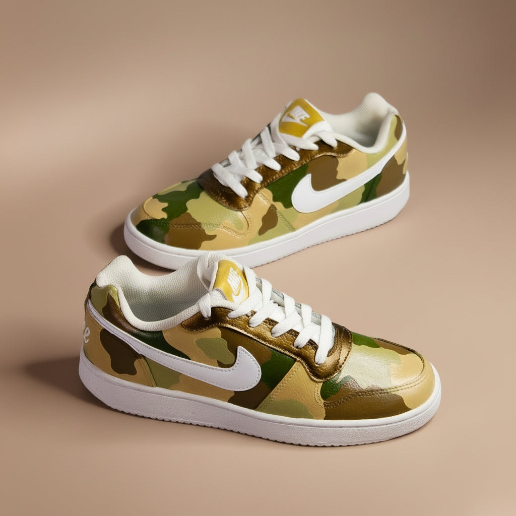 Hand-painted sneakers with camouflage colour pattern with shades of green and brown  on a light bronze background